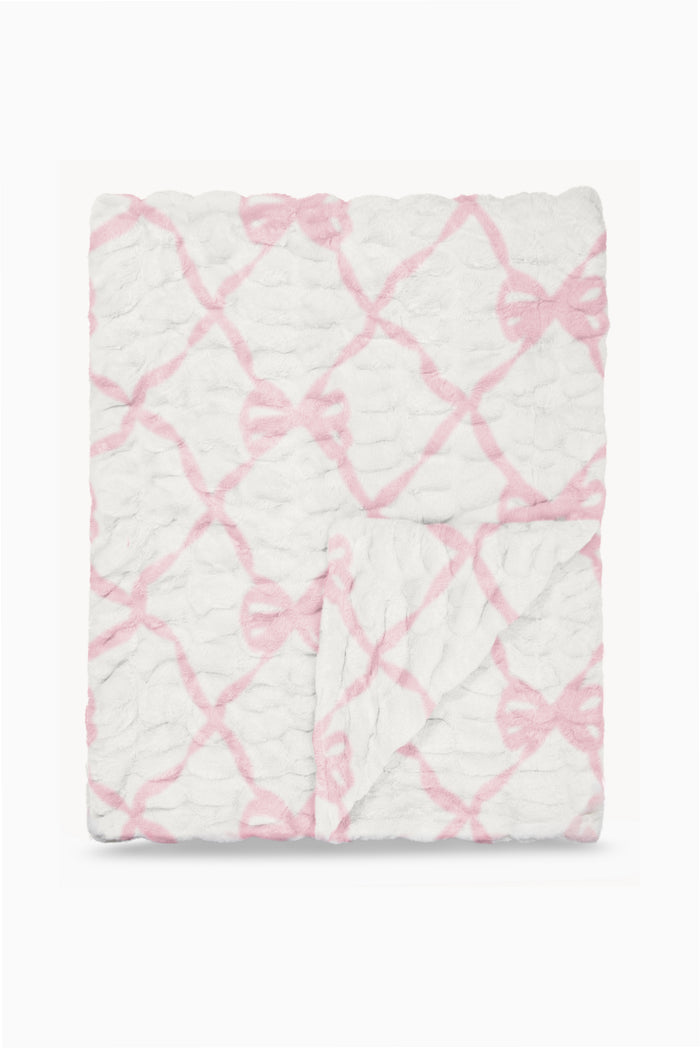 Folded fleece-style blanket with pink bow lattice pattern on white background