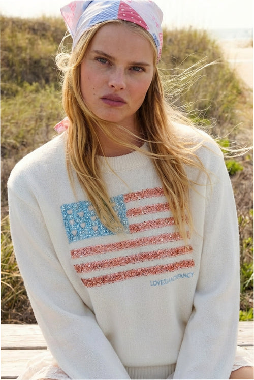 White knit pullover sweater with sparkling Americana flag graphic on chest