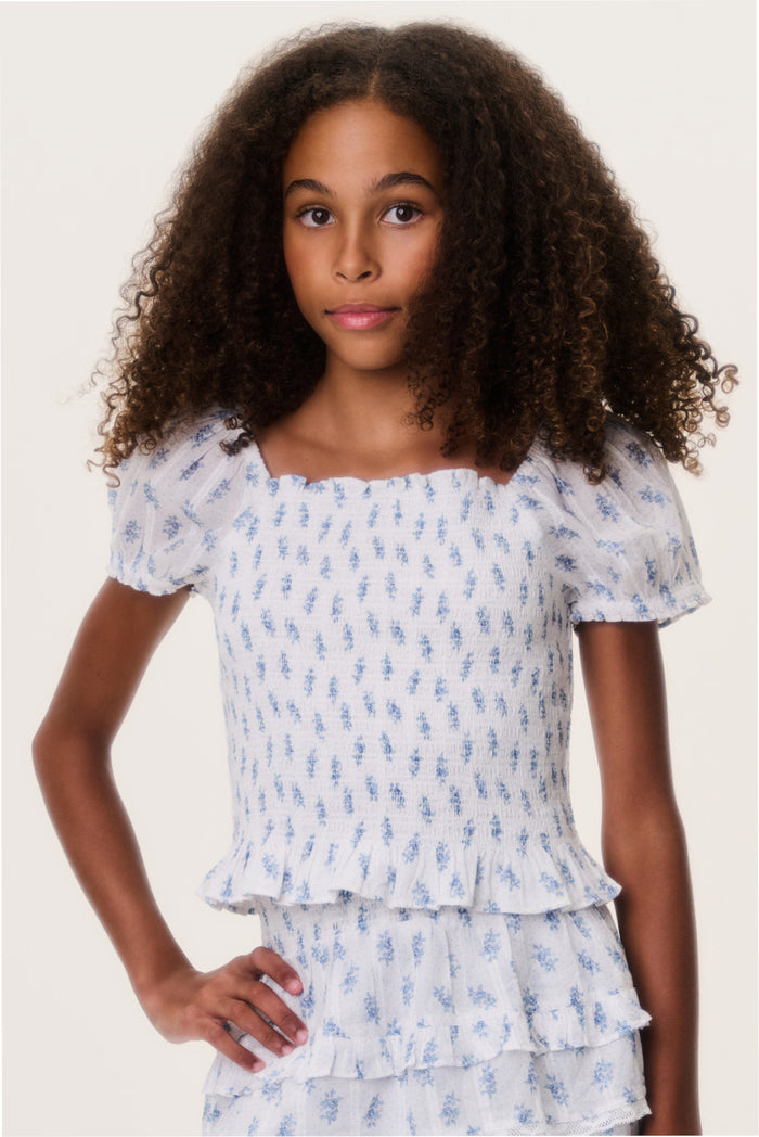 Light blue printed tween top with puff sleeves, square neckline, and tiered ruffles