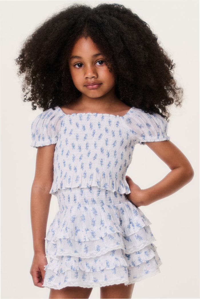 Light blue girls top with short puff sleeves and tiered ruffle hem