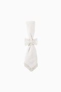 White cloth napkin with bow tie and lace-edged hem, neatly folded