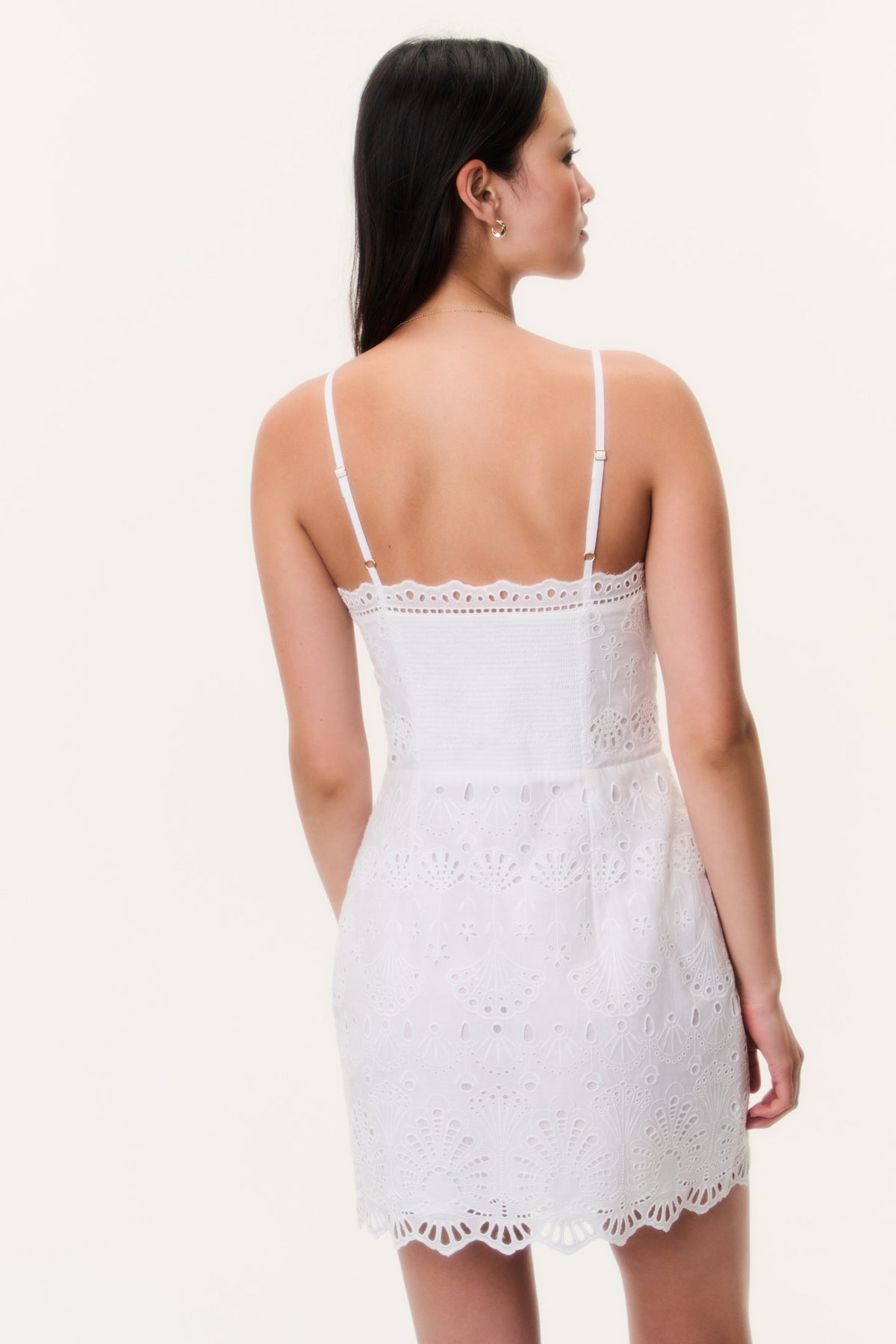 Eyelet cotton mini dress back view with thin straps and lace pattern