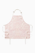 Perennial pink printed apron, front flat lay with adjustable straps and ties