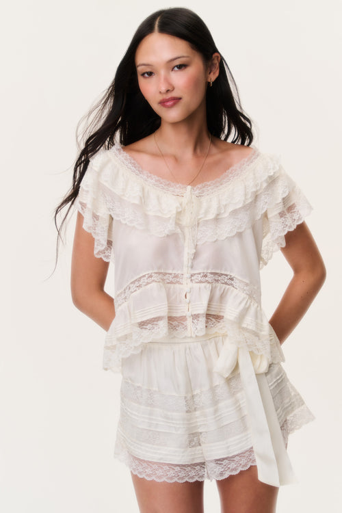 Ivory lace shorts with tiered seam detail and scalloped lace trim