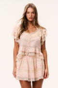 Petal peach silk mini skirt with lace-trimmed tiers and scalloped hem