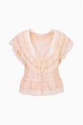 Light peach silk ruffle top with lace trim, short sleeves, and button front