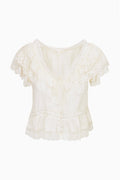 Ivory silk ruffle top flat lay: V-neck lace ruffles, short sleeves, tiered front detail