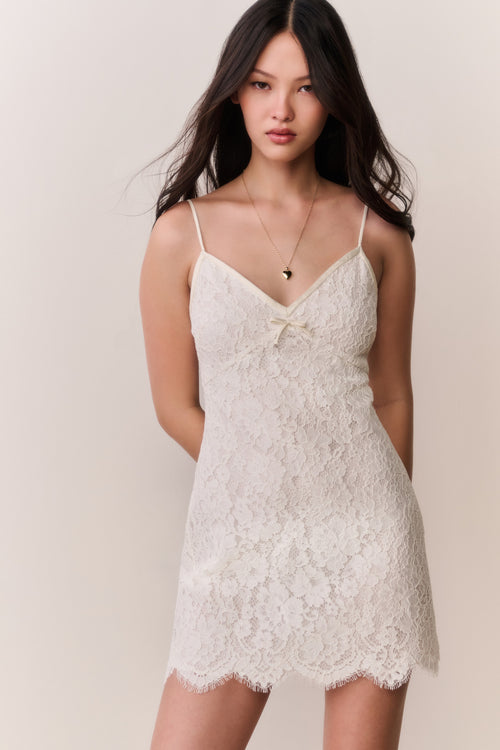 Ivory lace mini dress on model, spaghetti straps and lace V-neck bodice