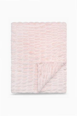 Folded throw blanket in petal pink textured with a soft, frosted finish