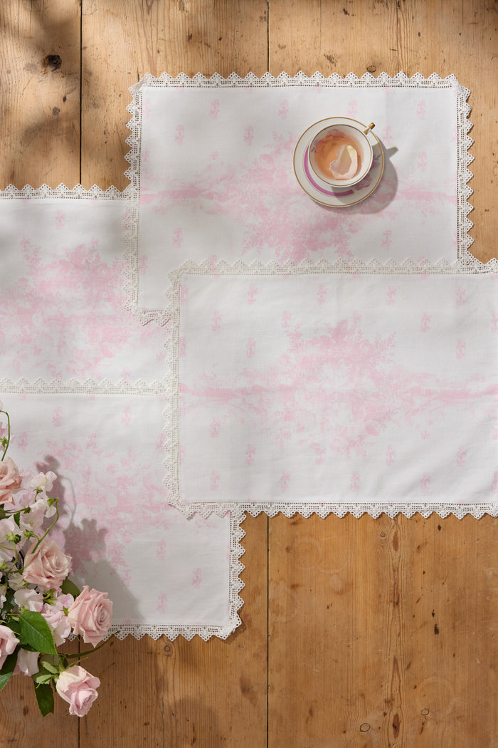 Set of four pink Victorian place mats with scalloped lace border and floral print