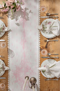 Pink printed table runner with Victorian floral pattern and lace scalloped edges