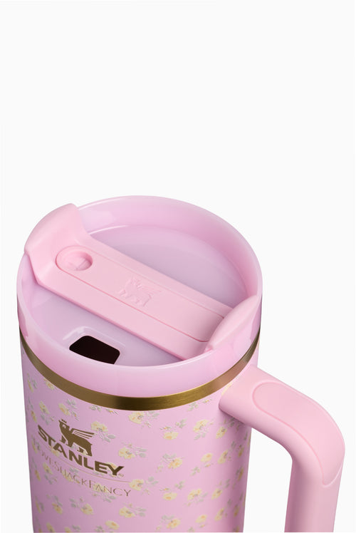 Pink tumbler lid with slide opening and flip spout; gold rim and handle visible