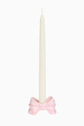 Pink porcelain bow candlestick holder with white pillar candle