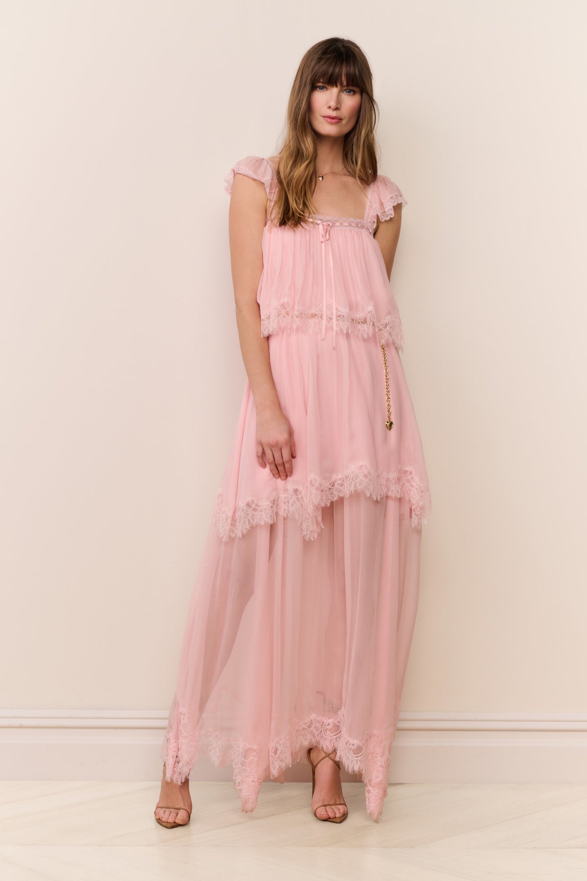 Pink silk chiffon maxi dress with cap sleeves, lace-trim tiers, and flowing sheer skirt