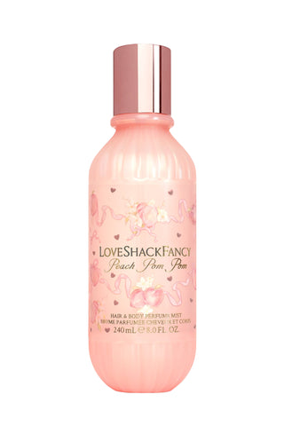 Peach-pink hair and body perfume mist bottle with metallic rose-gold cap