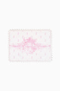 Pink floral place mat with scalloped lace edge and Victorian-style pattern