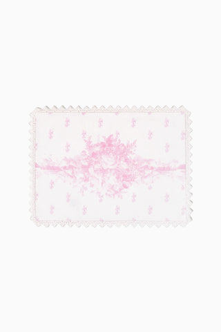 Pink floral place mat with scalloped lace edge and Victorian-style pattern