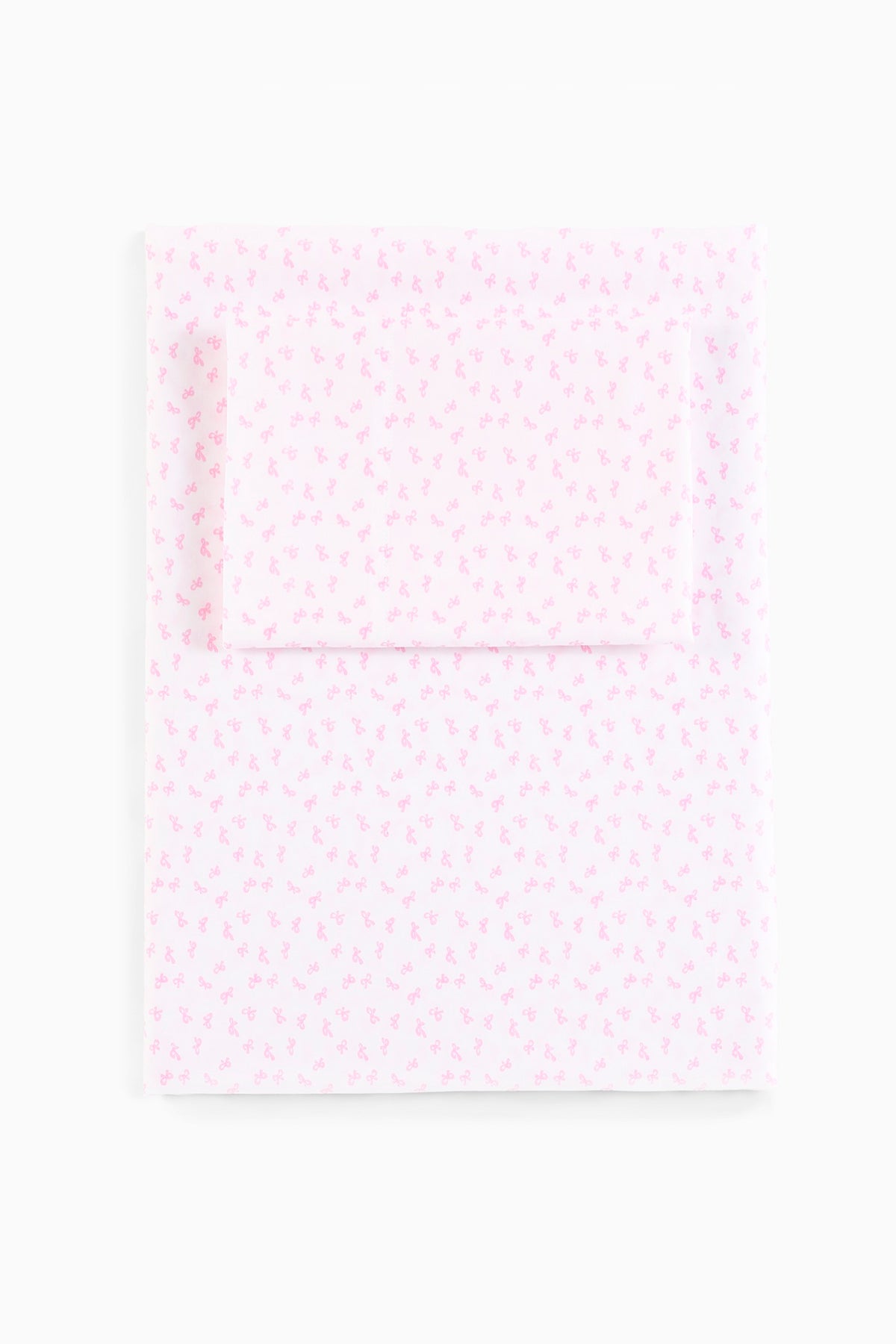 Printed cotton sheet set with pink all-over bow pattern, flat view
