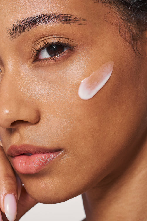 Facial serum swatch on cheek and jawline, smooth skin finish