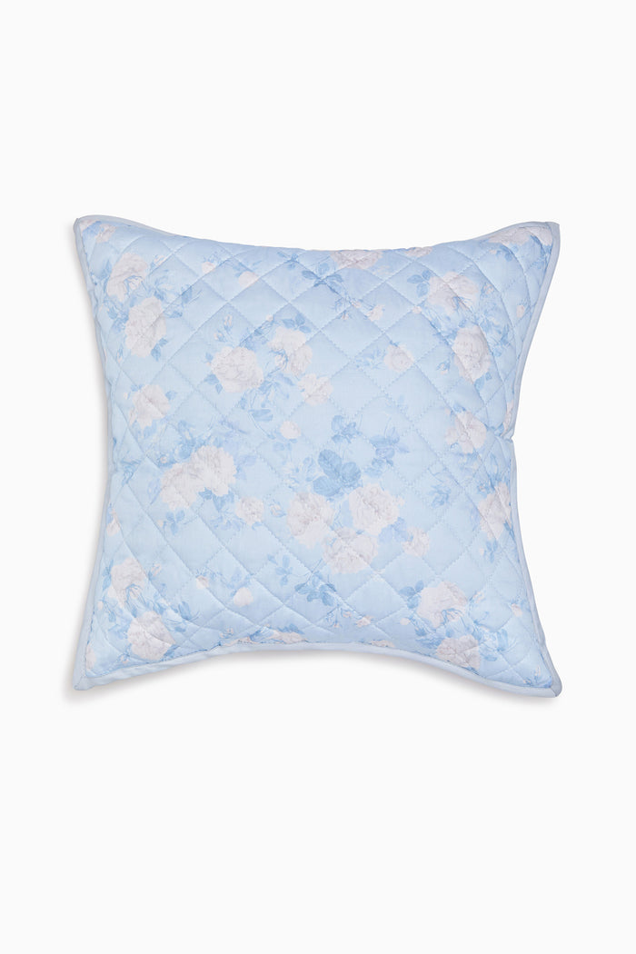 Blue quilted pillow with floral pattern 