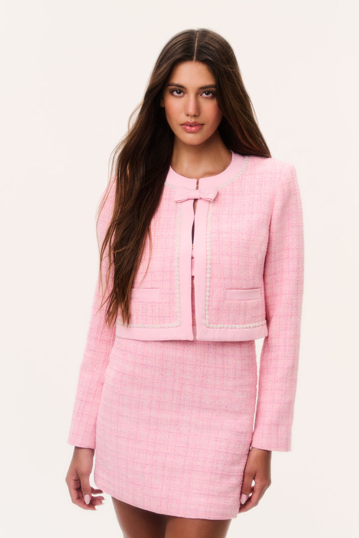 Pink tweed jacket with pearl trim, zip front, and flap pockets