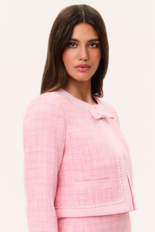 Pink tweed jacket with pearl-trimmed shoulder seam and chest flap pocket