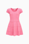 Pink pointelle knit tiered mini dress with cap sleeves and crew neckline