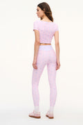 Lilac mixed-print active crop top in back view with scoop neck and short sleeves