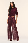 Faded merlot sheer lace wide-leg pants with bow-tied waist and draped fit.