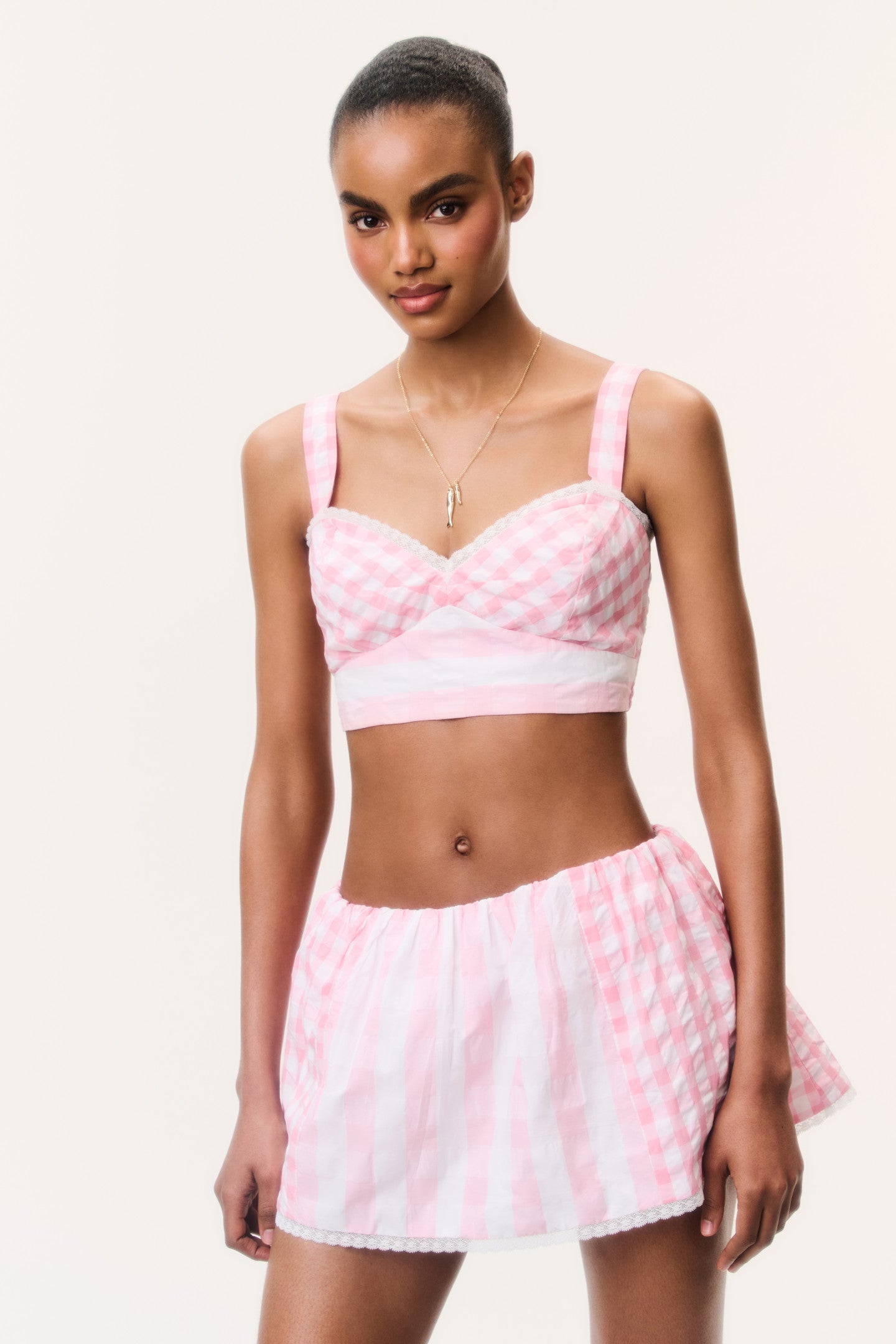 Women sitting in grass field wearing LoveShackFancy Slip Dresses
