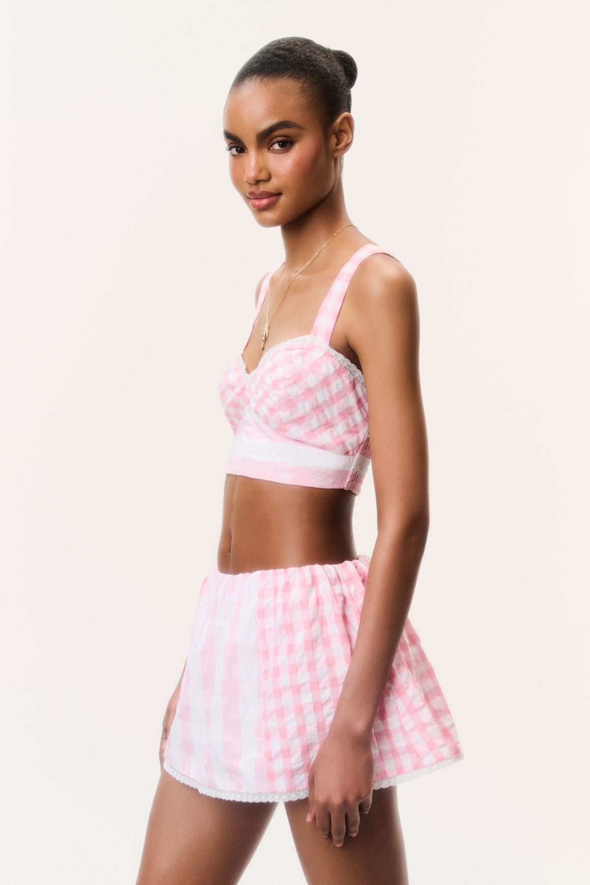 Pink seersucker bralette top with thin straps, seen from the side