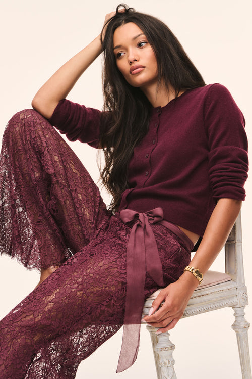 Burgundy cashmere cardigan with button front and long sleeves, draped styling