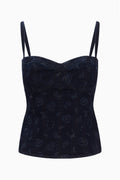 Dark blue denim bustier with sweetheart neckline, spaghetti straps, and allover laser print