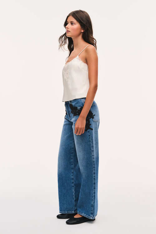 Wide-leg indigo jeans with black lace appliqué and high waist