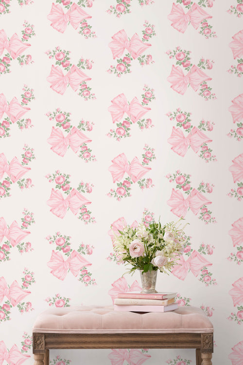 Peel-and-stick wallpaper pattern of pink bows, roses, and mint-green leaves on wall