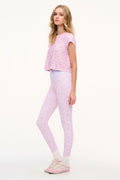 Light mauve mixed-print leggings, full-length, worn in side profile