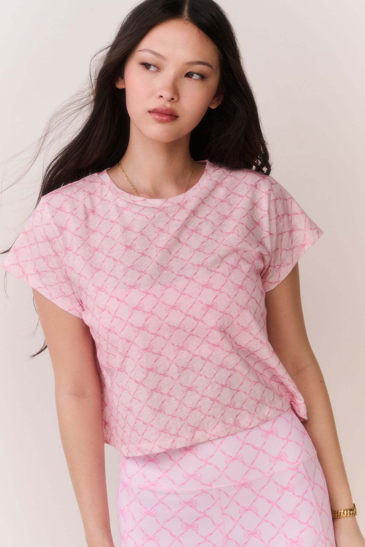 Pink cropped tee with textured lattice pattern and crew neck, front view