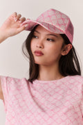 Pink patterned trucker hat with curved brim and mesh back