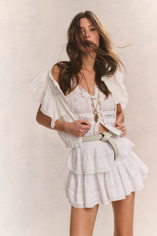 White tiered ruffle mini skirt with layered tiers and flounce hem