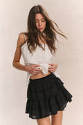 Black tiered ruffle mini skirt with gathered waist and layered flounce tiers