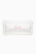 White lumbar pillow with pink embroidered love motif and ruffled edges