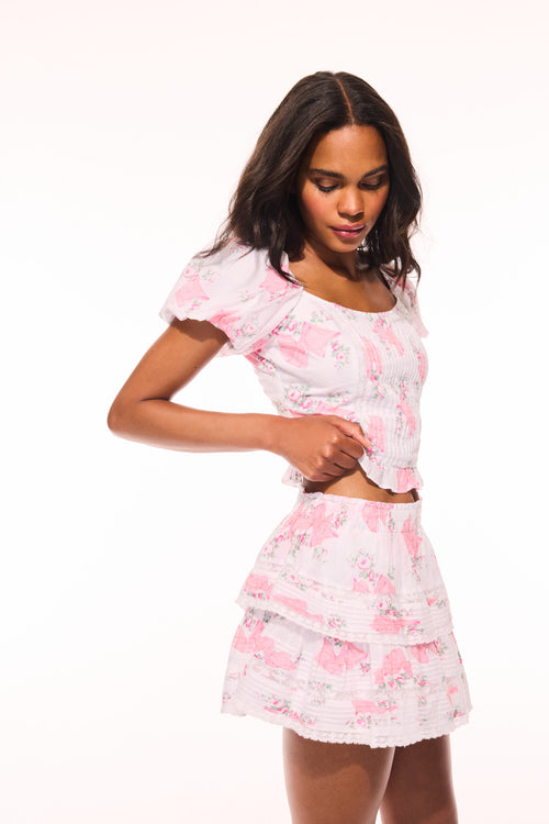 Pink floral ruffle mini skirt with layered tiers and short hem