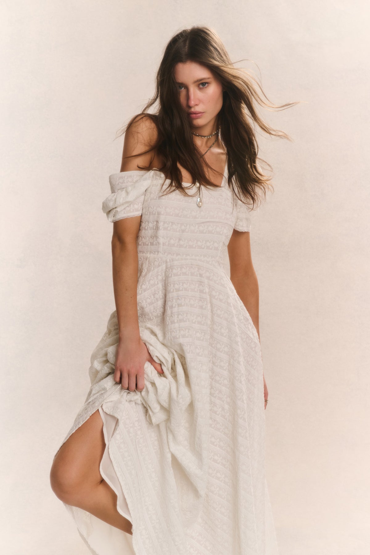 Ivory lace maxi dress with off-shoulder neckline, fitted bodice, flowing skirt