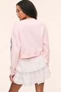 Primrose pink long-sleeve pullover sweater with ribbed crew neck and hem