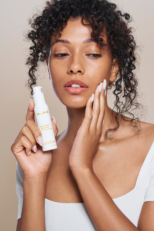 Retinol renewal serum bottle with pump; person holds skincare applicator.