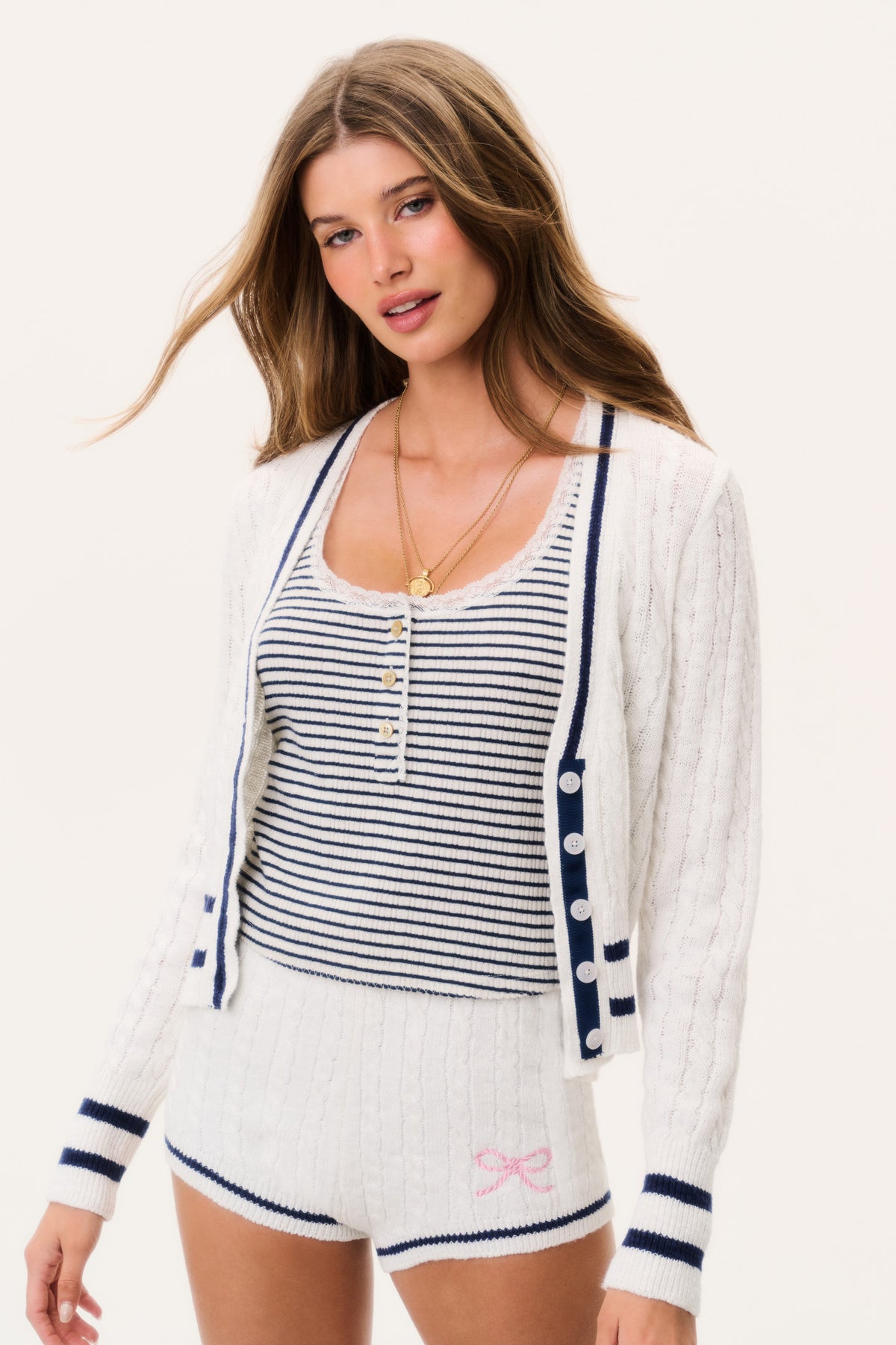 Ivory cable-knit cardigan with V-neck, navy trim, button front