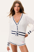 Ivory cable-knit cardigan with V-neck, navy button front, striped hem