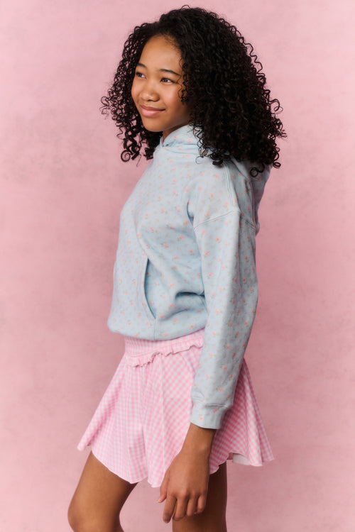 Pink gingham skort with flared pleated hem, side view