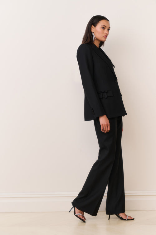 Black wool-blend blazer with notched lapel and bow-trim pocket flap details