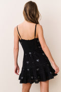 Black cotton mini dress with spaghetti straps and crystal bow embellishment, tiered skirt
